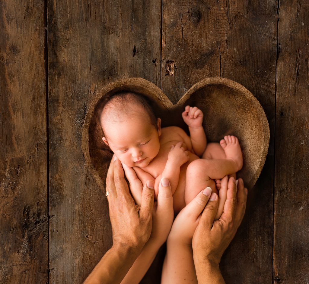 Baby in Heart Bowl with Parent's Hands